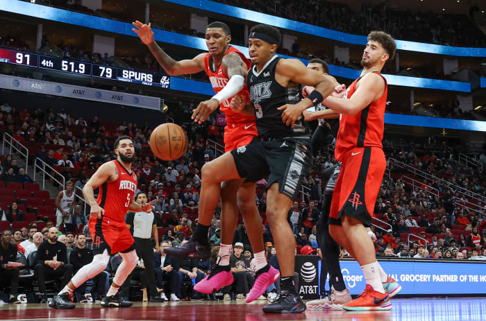 Rockets forward Jabari Smith Jr. (10) and San Antonio Spurs forward Keldon Johnson (3) attempt to get a loose ball during the fourth quarter at Toyota Center.